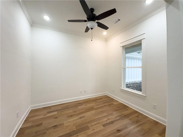 empty room featuring ceiling fan, hardwood / wood-style floors, and crown molding