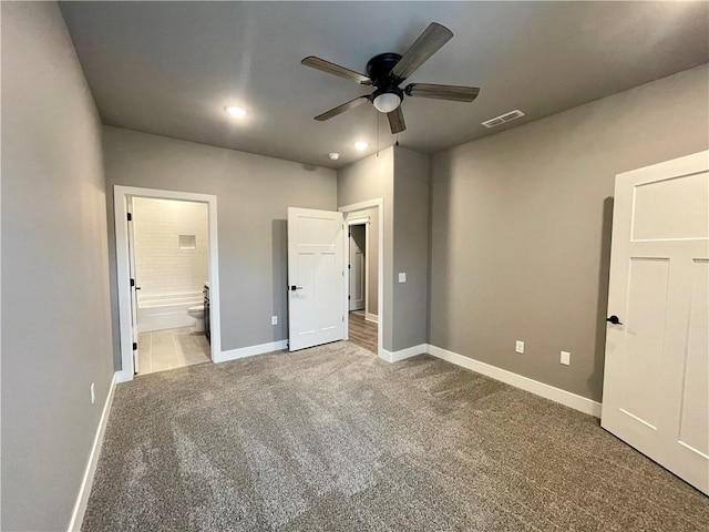 unfurnished bedroom featuring carpet, ensuite bathroom, and ceiling fan