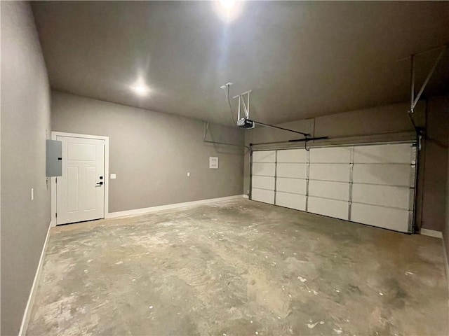 garage featuring electric panel and a garage door opener