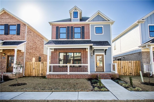 view of front of house featuring covered porch and a front yard