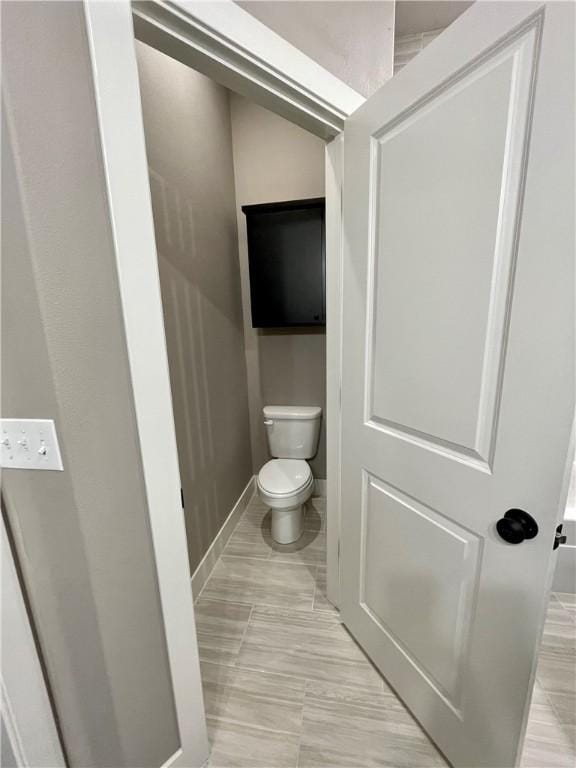 bathroom with tile patterned floors and toilet