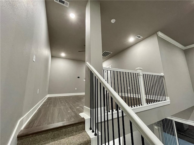 staircase featuring ornamental molding