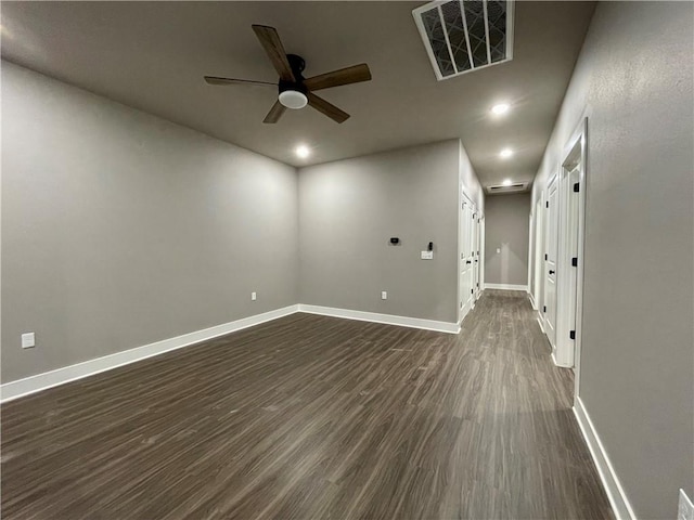 spare room with dark hardwood / wood-style floors and ceiling fan