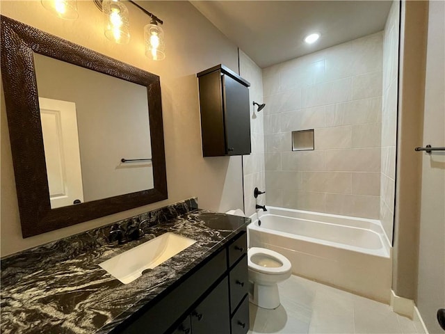 full bathroom featuring tile patterned floors, tiled shower / bath combo, toilet, and vanity