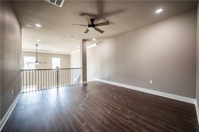 unfurnished room featuring dark hardwood / wood-style floors, ceiling fan, and ornamental molding