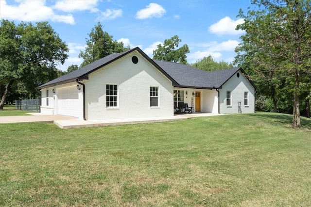 back of house with a yard and a garage