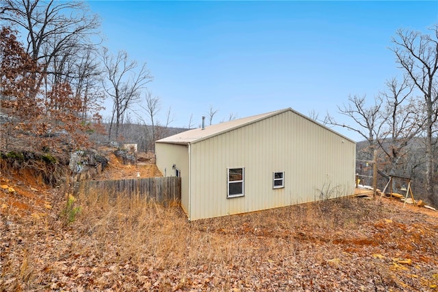 view of home's exterior featuring fence