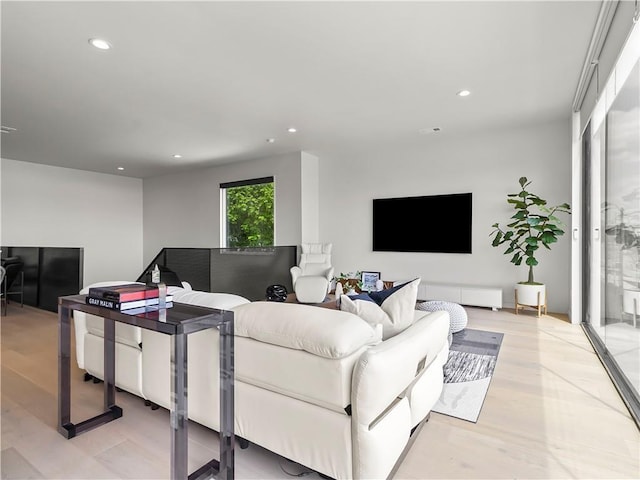 living area with recessed lighting and light wood finished floors