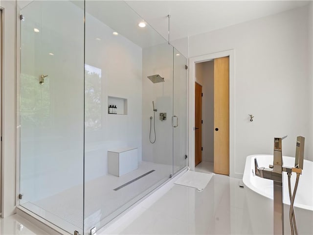 full bath featuring a stall shower, a freestanding tub, and recessed lighting