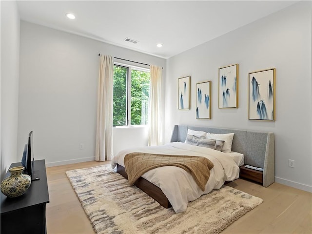 bedroom with baseboards, recessed lighting, visible vents, and light wood-style floors