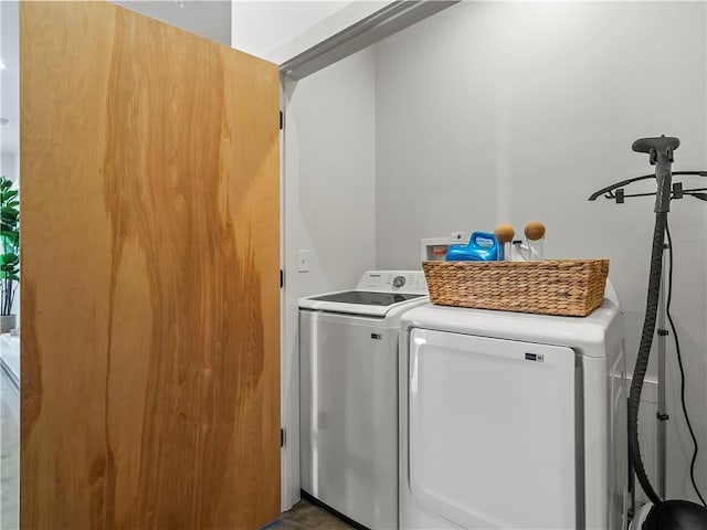 clothes washing area with separate washer and dryer