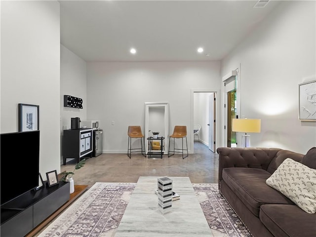 living room featuring concrete flooring