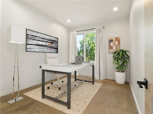 office area featuring finished concrete flooring, baseboards, and recessed lighting