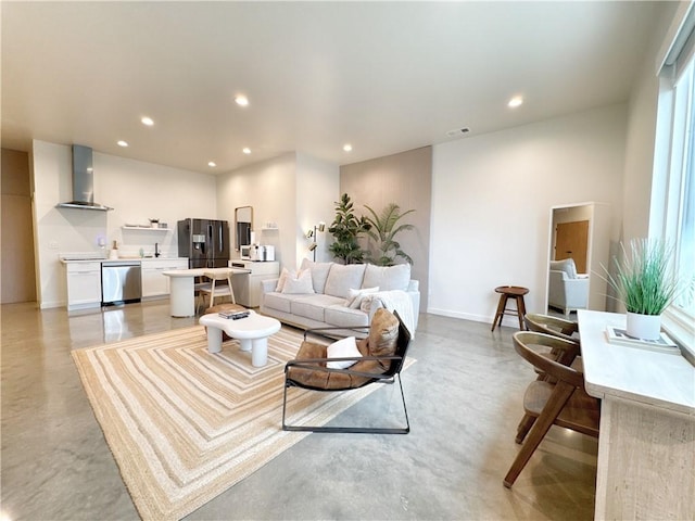 living room featuring finished concrete floors, visible vents, and recessed lighting