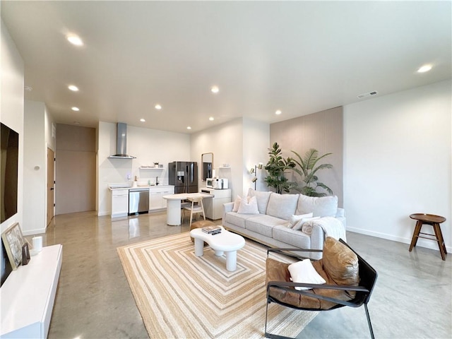 living room with baseboards, finished concrete flooring, visible vents, and recessed lighting