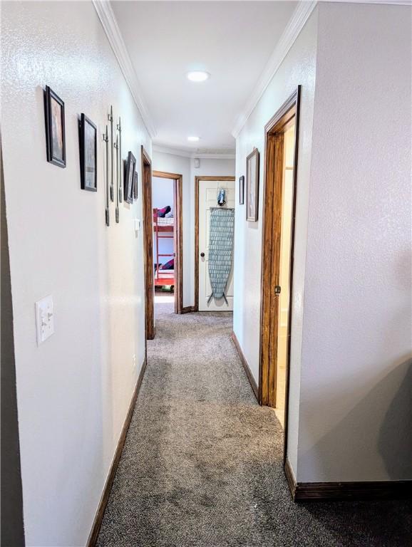 corridor featuring carpet and crown molding