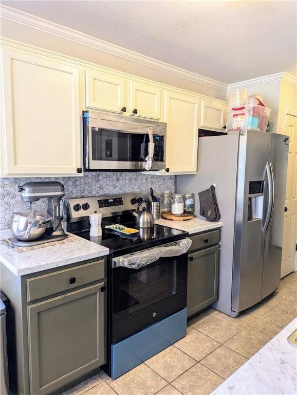 kitchen featuring gray cabinetry, white cabinets, light tile patterned floors, ornamental molding, and stainless steel appliances