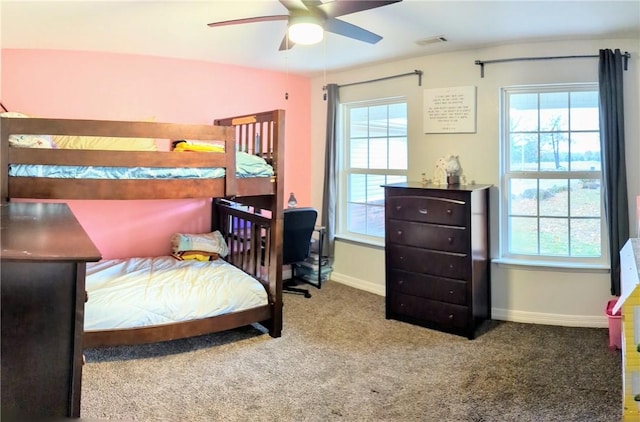 carpeted bedroom featuring ceiling fan and multiple windows