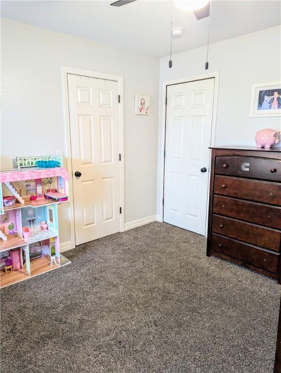 playroom featuring ceiling fan and dark carpet