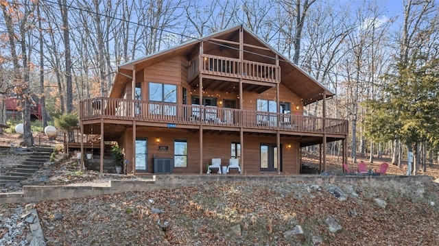 back of house featuring stairway and a wooden deck