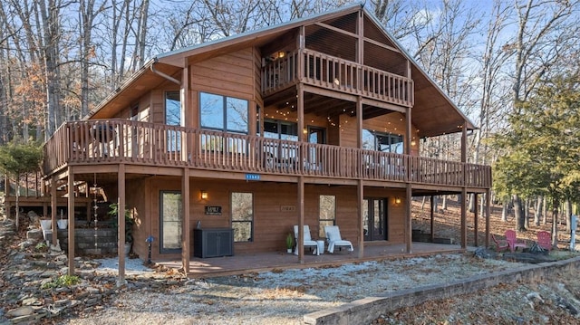 rear view of property featuring a patio and a deck