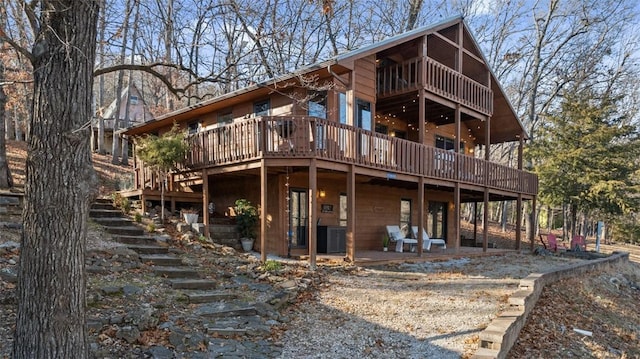 back of house with stairs, a patio area, a wooden deck, and central air condition unit