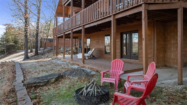 view of patio featuring a fire pit, a deck, and french doors