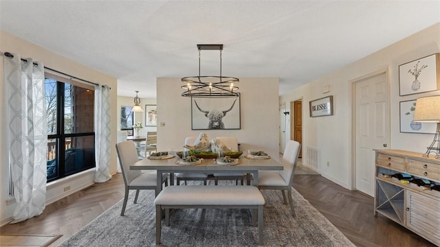 dining room with visible vents and baseboards