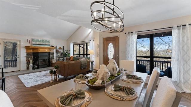 dining space featuring lofted ceiling and a notable chandelier