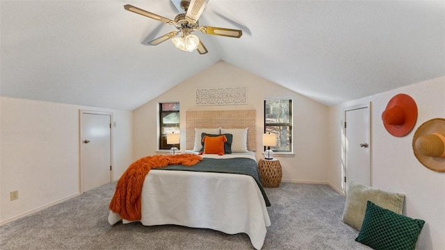 carpeted bedroom featuring a ceiling fan, lofted ceiling, and a textured ceiling