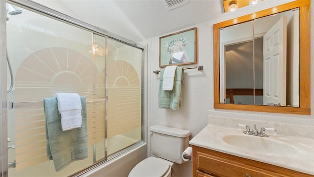 bathroom featuring toilet, visible vents, combined bath / shower with glass door, and vanity