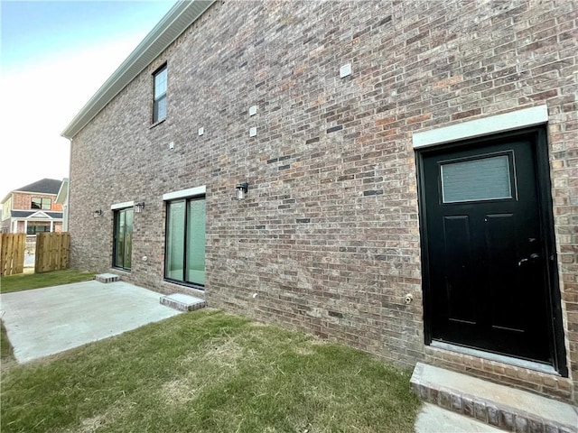 back of property with a patio area and a lawn