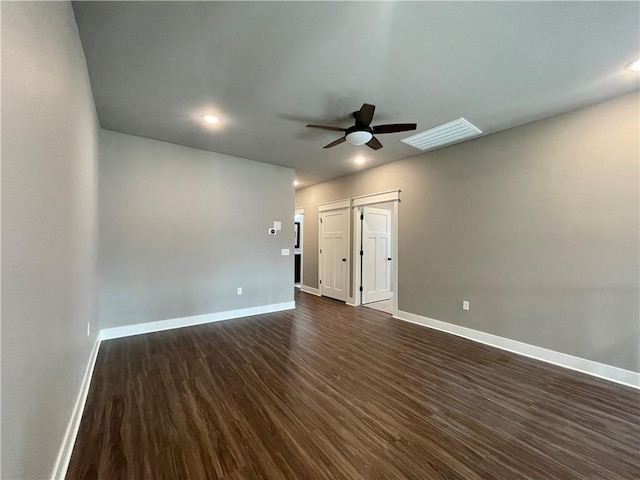 spare room with ceiling fan and dark hardwood / wood-style flooring