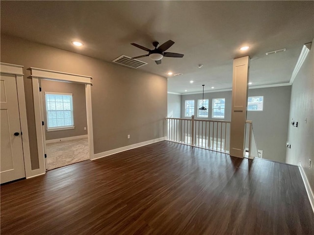 unfurnished living room with ceiling fan, dark hardwood / wood-style flooring, and ornamental molding