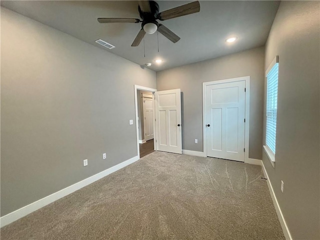 unfurnished bedroom featuring carpet and ceiling fan