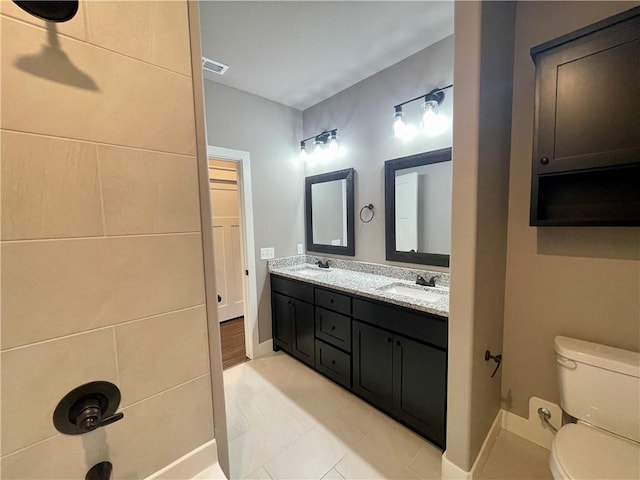 bathroom with tile patterned floors, vanity, and toilet