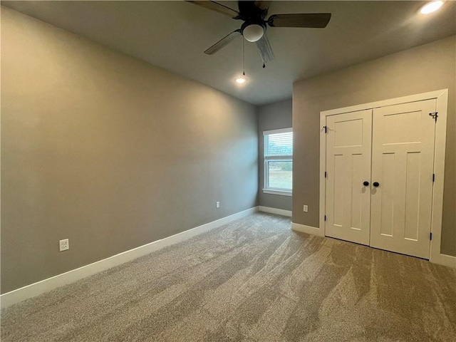 unfurnished bedroom with carpet floors, a closet, and ceiling fan