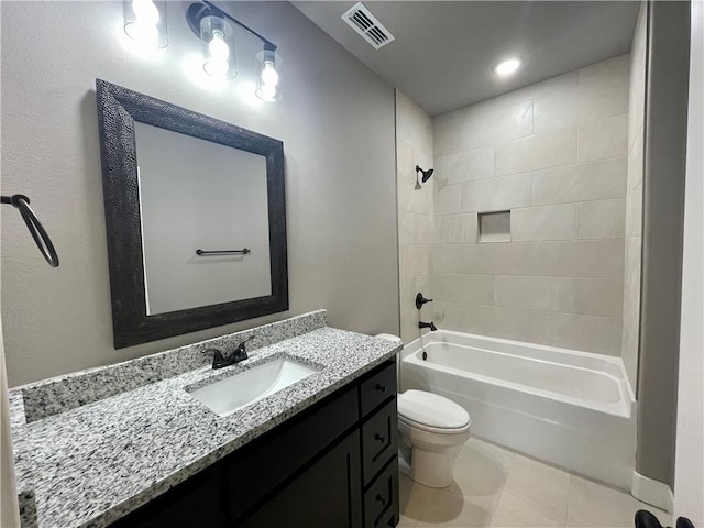 full bathroom featuring tile patterned flooring, vanity, toilet, and tiled shower / bath