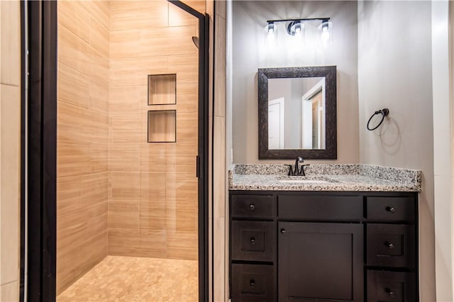 bathroom featuring vanity and tiled shower