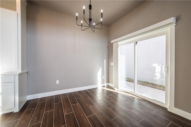 unfurnished dining area featuring a chandelier and plenty of natural light