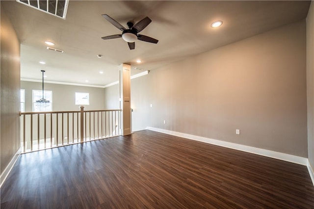 unfurnished room with ceiling fan, dark hardwood / wood-style floors, and ornamental molding