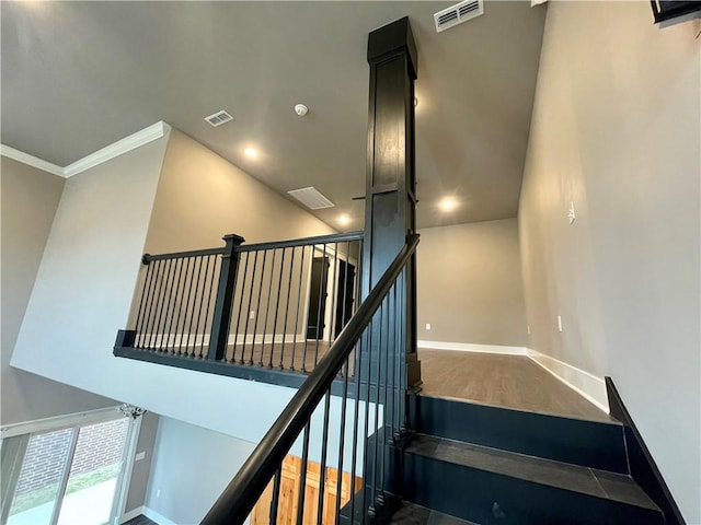 staircase featuring ornamental molding