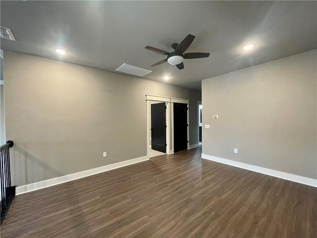 spare room featuring ceiling fan and dark hardwood / wood-style flooring