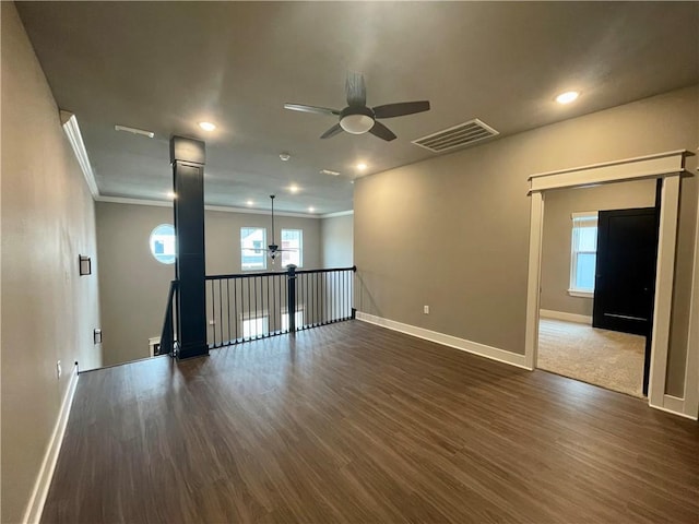 spare room with ceiling fan, dark hardwood / wood-style floors, and ornamental molding