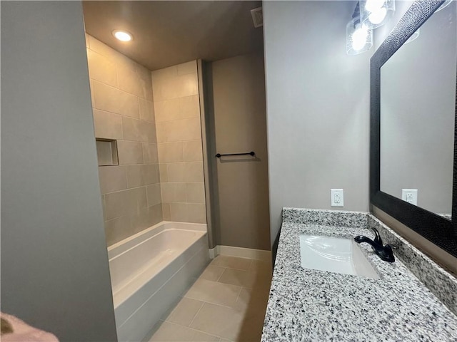 bathroom with tile patterned flooring, vanity, and tiled shower / bath combo