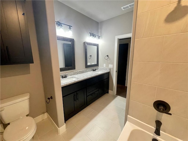 bathroom featuring tile patterned flooring, vanity, and toilet