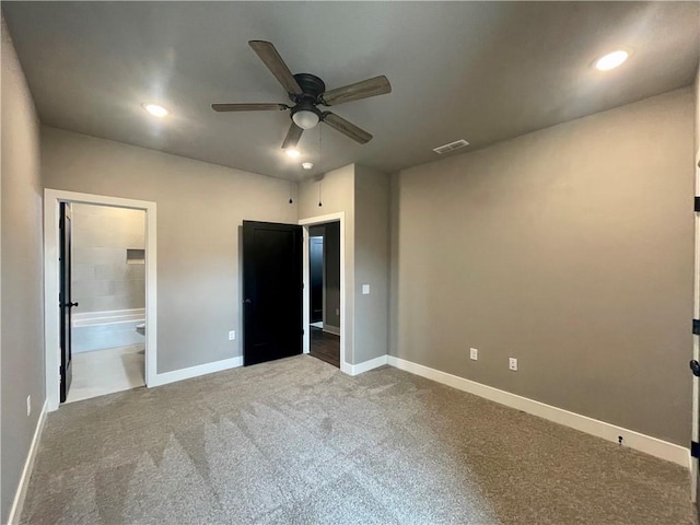 unfurnished bedroom with carpet flooring, ensuite bath, and ceiling fan