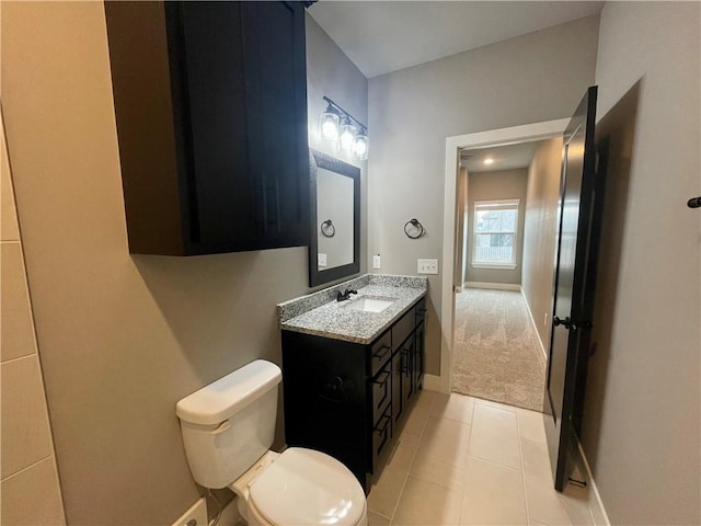 bathroom featuring tile patterned flooring, vanity, and toilet