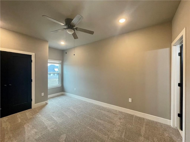 unfurnished bedroom featuring ceiling fan and light colored carpet