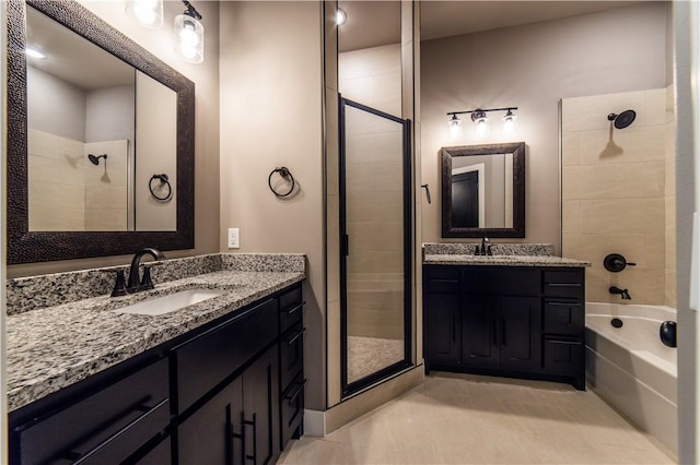 bathroom featuring tile patterned flooring, vanity, and shower with separate bathtub